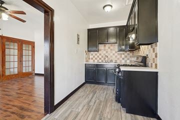 Torrance apartment for rent - A kitchen with black cabinets and a wooden floor.